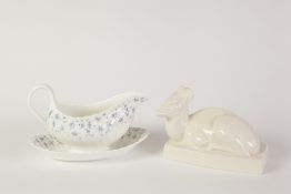 WEDGWOOD WHITE GLAZED STYLISED MODEL OF A RECUMBENT DEER, ON AN OBLONG BASE, HAND PAINTED NORITAKE