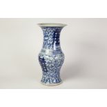 CHINESE BLUE AND WHITE PORCELAIN GU SHAPED VASE, decorated with bold character type marks, on a