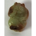 CHINESE QING DYNASTY TINY CELADON JADE CARVING with russet inclusions of a bear, pierced through for