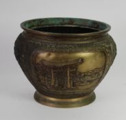 A JAPANESE MEIJI PERIOD PATINATED COPPER ALLOY JARDINIERE CAST WITH OPPOSING LANDSCAPE PANELS within