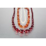 A GRADUATED FACET CUT BEAD NECKLACE of scarlet translucency, TOGETHER with a Cornelian bead NECKLACE