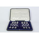 AN EARLY 20TH CENTURY CASED SET OF TWELVE SILVER TEASPOONS WITH A PAIR OF SUGAR TONGS, SHEFFIELD