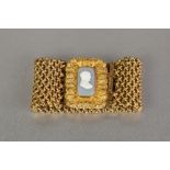 WILLIAM IV STYLE GILDED PINCHBECK WOVEN CUFF BRACELET, set with green and white glass oblong
