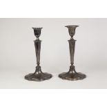 PAIR OF GEORGIAN STYLE WEIGHED SILVER TABLE CANDLESTICKS by Walker and Hall, each of oval,