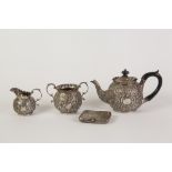 A LATE VICTORIAN SILVER THREE PIECE BACHELOR TEA SERVICE, embossed autor with foliate scrollwork,
