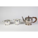 BROOK AND SON, EDINBURGH ARTS AND CRAFTS FLAVOUR PLANISHED SILVER THREE PIECE TEA SET, of ovoid