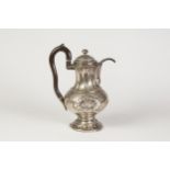 A NINETEENTH CENTURY GERMAN (NUREMBERG) SILVER COFFEE POT, with stained boxwood handle, a baluster