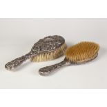TWO EDWARD VII EMBOSSED SILVER BACKED HAIR BRUSHES (2)