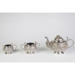 AN INDIAN SILVER COLOURED METAL TEA SERVICE OF THREE PIECES, globular and raised on plain circular