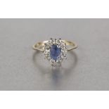 18ct GOLD CLUSTER RING, set with an oval Ceylon sapphire and surround of ten diamonds, ring size 'K'