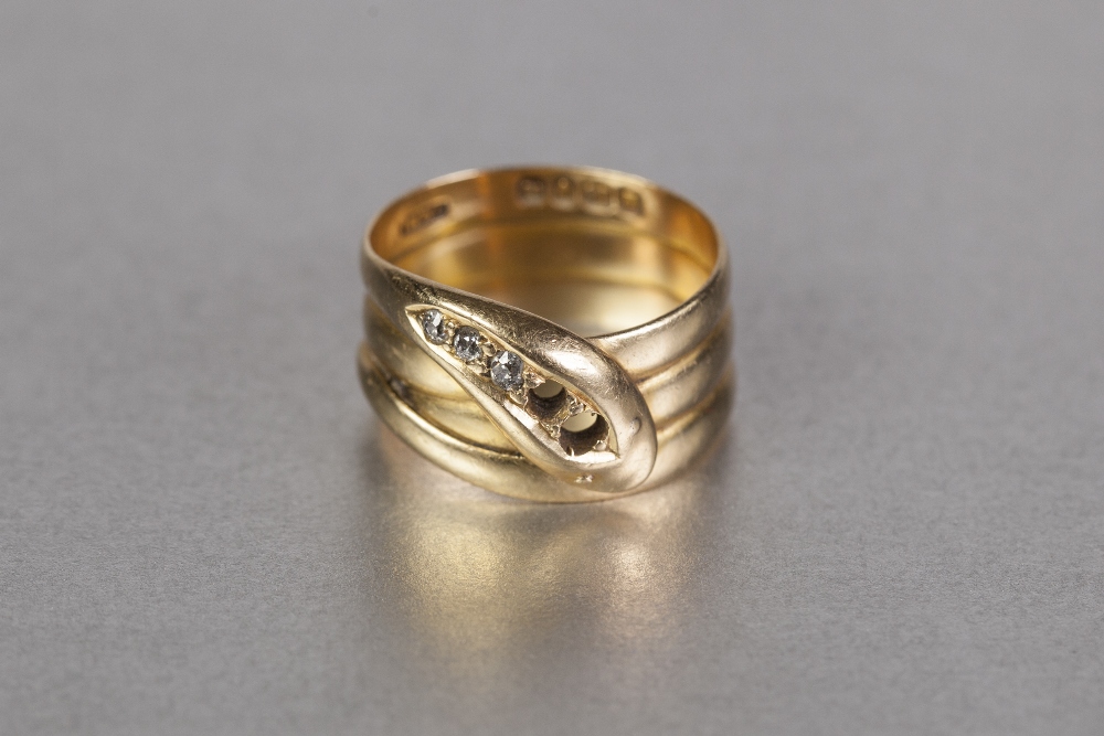 LATE VICTORIAN 18ct GOLD SNAKE RING, of broad three 'Coil' pattern, the head set with three tiny