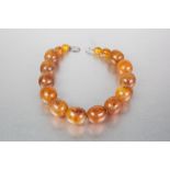 A PROBABLY INTER-WAR YEARS POSSIBLY RE-CONSTITUTED AMBER GRADUATED BEAD NECKLACE, each bead