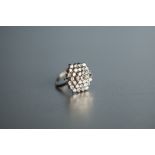 18ct WHITE GOLD AND DIAMOND HEXAGONALLY DOMED CLUSTER RING, of four tiers, thirty five small