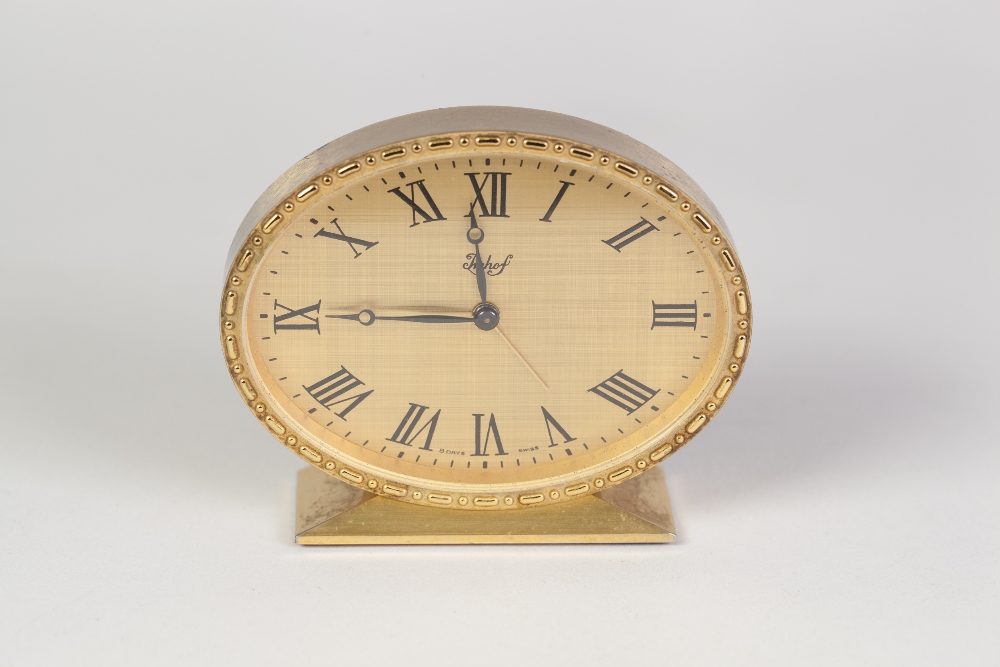 IMHOF, SWISS SMALL MANTEL CLOCK, with 8 days alarm movement, with gold coloured metal Roman oval