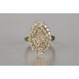 18ct GOLD RING, with a marquise shaped four tier cluster of forty three small uniform round