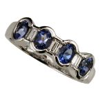 18ct WHITE GOLD, TANZANITE AND DIAMOND RING, collet set with a row of four oval tanzanites and three