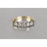 an 18ct YELLOW AND WHITE GOLD FIVE STONE DIAMOND SET HALF HOOP RING, each stone approx 0.10ct gross