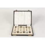 A POST WAR CASED SET OF SIX SILVER GILT AND GUILLOCHE ENAMEL COFFEE SPOONS, with black bead