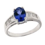 18ct WHITE GOLD, TANZANITE AND DIAMOND RING, set with an oval tanzanite and having five channel
