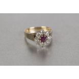 18cT GOLD RUBY AND DIAMOND DAISY CLUSTER RING, set with a circular centre ruby approx 5mm