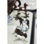 A GROUP OF THREE BESWICK HORSE FIGURINES, A STANDING DARK BROWN, LAID DOWN DARK BROWN AND WHITE