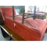 AN OTTOMAN COUCH WITH SINGLE SCROLL END, COVERED IN CRIMSON VELVET