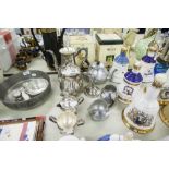 A SILVER PLATE TEA/COFFEE SERVICE OF FOUR PIECES AND ANOTHER OF THREE PIECES