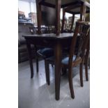 A MID TWENTIETH CENTURY DARK MAHOGANY EXTENDING DINING TABLE, WITH EXTRA LEAF ON FOUR SUPPORTS