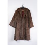 A LADIES DARK BROWN SHORT FUR JACKET FOLD OVER COLLAR, 2 decorative buttons, hidden side pockets ,