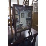 A VICTORIAN FIRE SCREEN, OAK FRAME WITH NEEDLEWORK SCENE OF A SEATED WOMAN READING
