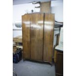 A VICTORIAN WALNUT BEDROOM SUITE COMPRISING; DRESSING TABLE WITH SHAPED TRIPLE MIRROR AND WARDROBE