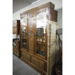 A VICTORIAN BEDROOM SUITE OF THREE PIECES VIZ, A TRIPLE WARDROBE WITH MIRRORS TO EACH DOOR, TWO