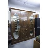 LATE NINETEENTH CENTURY INLAID OAK BEACONSFIELD TYPE WARDROBE WITH TWO OVAL MIRROR PANEL DOORS (A.