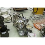 A SILVER PLATE TEA/COFFEE SERVICE OF FOUR PIECES AND ANOTHER OF THREE PIECES