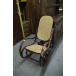 A MODERN BENTWOOD ROCKING CHAIR WITH CANE PANEL BACK AND SEAT