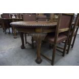 A MAHOGANY OVAL EXTENDING DINING TABLE, OF CHIPPENDALE STYLE WITH GADROON CARVED EDGE ON FOUR