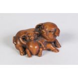 A JAPANESE WELL CARVED CARVED BOXWOOD NETSUKE, of a sow and piglet, glass inset eyes, signed with