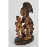 PUNU CARVED WOOD MATERNITY GROUP, modelled seated with a child and baby on her knee, the mother