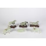 A SUITE OF SIX CHINESE CELADON JADE CARVED HORSES each with black inclusions, the models standing,