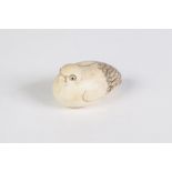 A JAPANESE CARVED IVORY NETSUKE (no holes) of a NESTING BIRD, with glass inset eyes, incised and