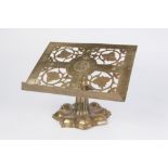 AN EARLY 20TH CENTURY BRASS TABLE EDITION in Arts and Crafts taste, the foliate pierced bible rest