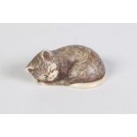 A JAPANESE WELL CARVED IVORY NETSUKE OF A CAT ASLEEP, the fur finely incised and black inked, signed