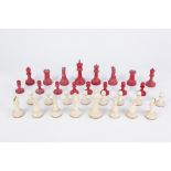 EARLY 20th CENTURY STAUNTON PATTERN NATURAL AND RED STAINED IVORY CHESS SET