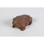 A JAPANESE WELL CARVED BOXWOOD NETSUKE OF A TOAD, signed with two characters