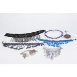 AN EASTERN CHAIN NECKLACE THE CRESCENT SHAPED FILIGREE FRONT; four beadwork choker necklace's and