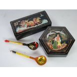 TWO MODERN RUSSIAN BLACK LACQUERED AND HAND PAINTED PAPIER MACHE BOXES, one of oblong form,