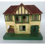 20th CENTURY PAINTED WOODEN AND METAL DOLLS HOUSE WITH GARAGE, on a green painted plinth base,