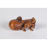 A JAPANESE WELL CARVED BOXWOOD NETSUKE of a mouse pulling a bag upon which is a smaller mouse,