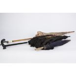 LADYS BLACK SILK PARASOL WITH ONE FLORAL embroidered panel and black lace fringe; a lady's 1920's