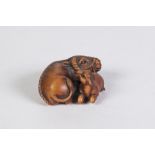 A JAPANESE WELL CARVED BOXWOOD NETSUKE, OF A WATER BUFFALO WITH A CALF, with glass inset eyes,